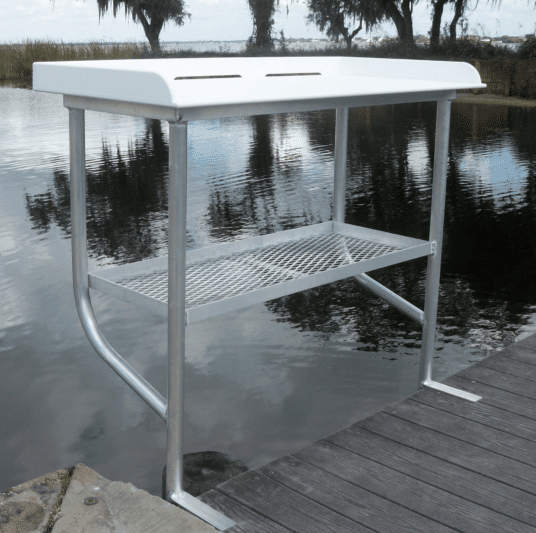 white fish table with two legs on a dock