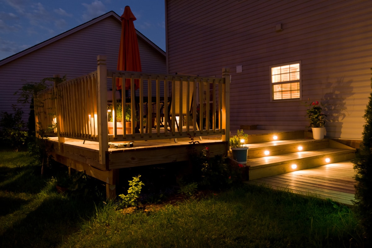 Wooden deck with button lights on at night