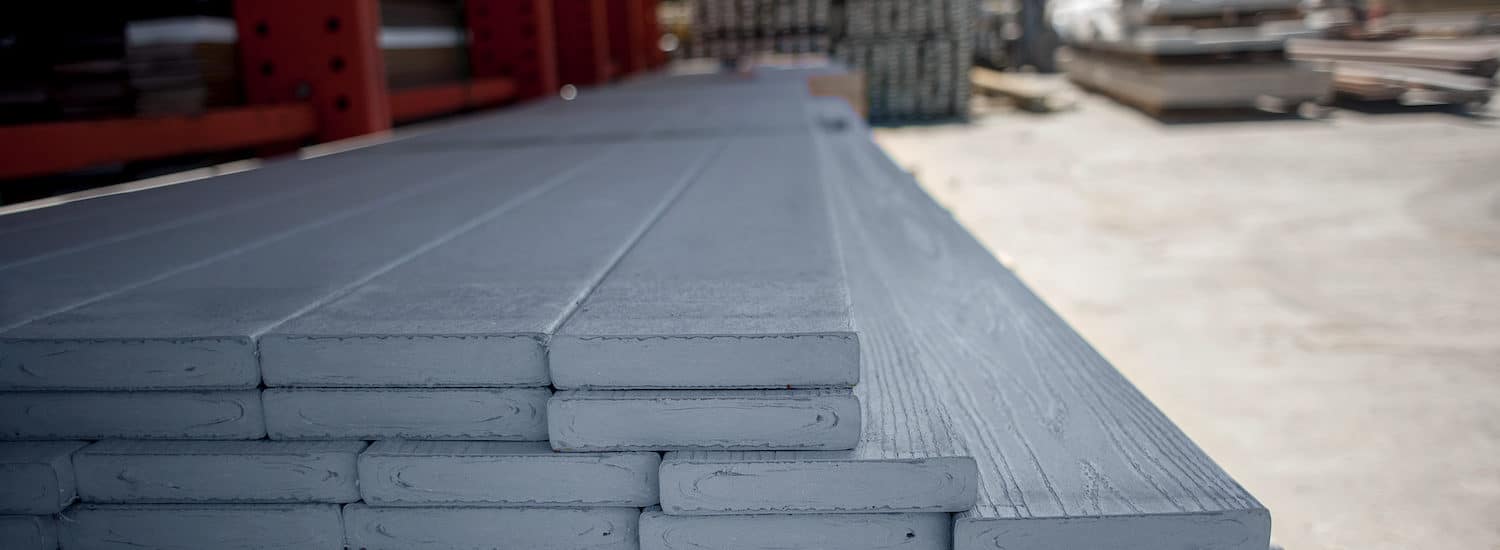 Stacked grey boards of WearDeck composite decking