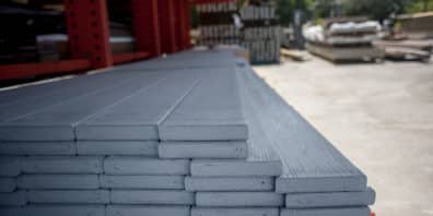 Stacked grey boards of WearDeck composite decking