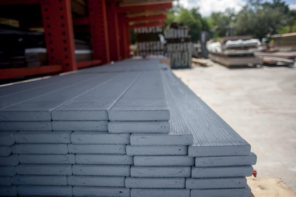 Stacked grey boards of WearDeck composite decking