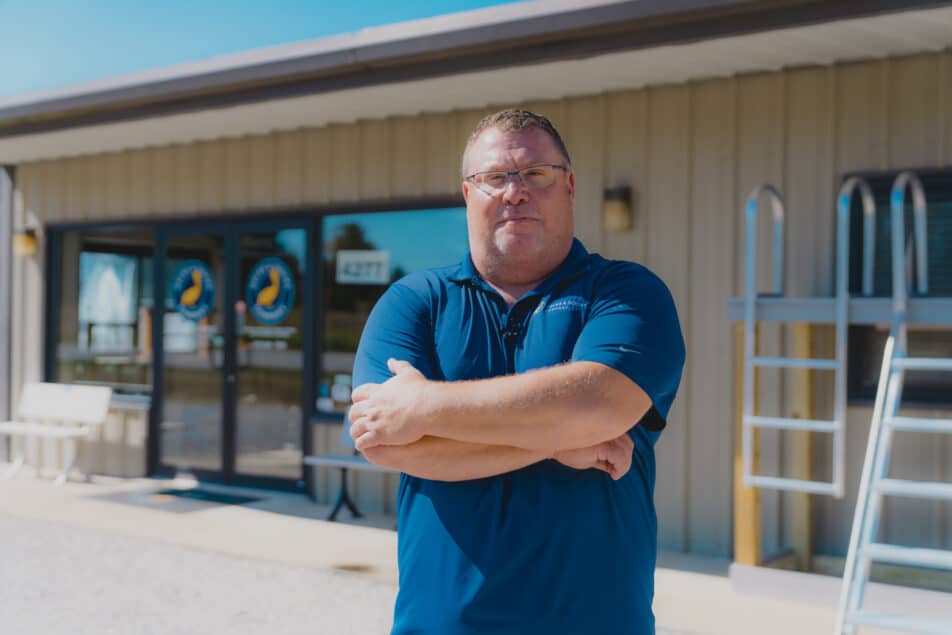 Eric Avondet man standing with his arms crossed in front of a lumber store