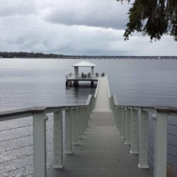 Trex Deck Select decking in Pebble Gray. Trex Transcend Railing in White with Stainless Steel Cable. Trex Accent Lights on Posts. , Lighting & Railing